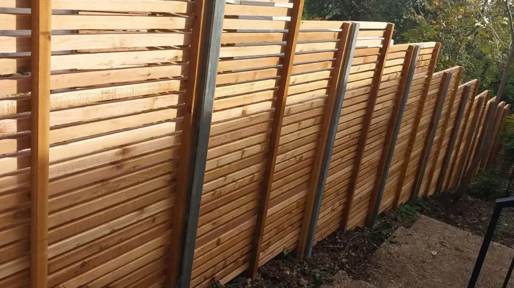 Wood fence with steel posts for enhanced strength and stability
