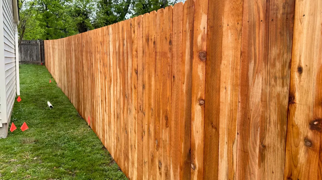 Newly installed wooden backyard fence for added privacy