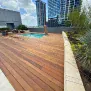 pvc-deck-repair-cedar-park Stained wood deck with pool for an elegant backyard retreat